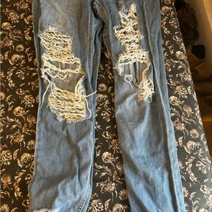 Distressed denim overalls